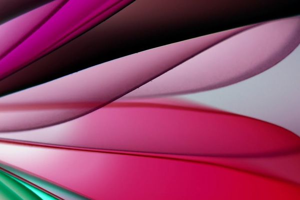 Abstract geometric patterns in green and pink tones.