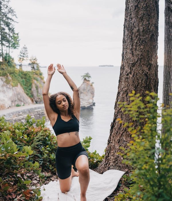 Woman performing a focused yoga pose in a calm environment.